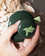 Photo image of a hand applying shampoo using a dog massage brush for Verdin Dog Shampoo