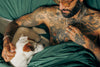 Photo Image of a Man and His Dog in Bed Together.