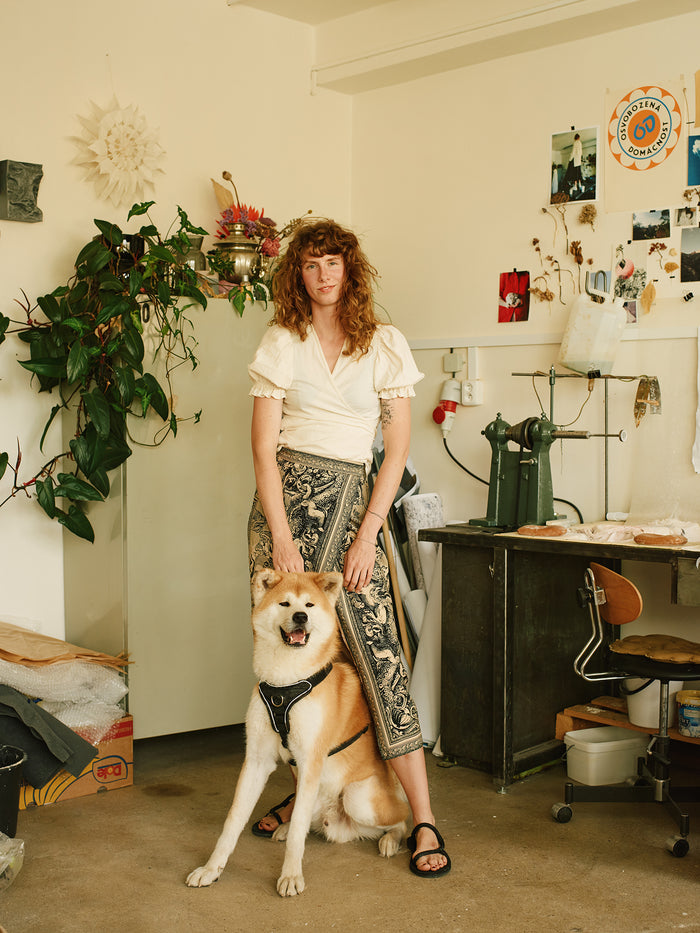 Photo Image of A Woman with her Dog Together In Their Living Room.